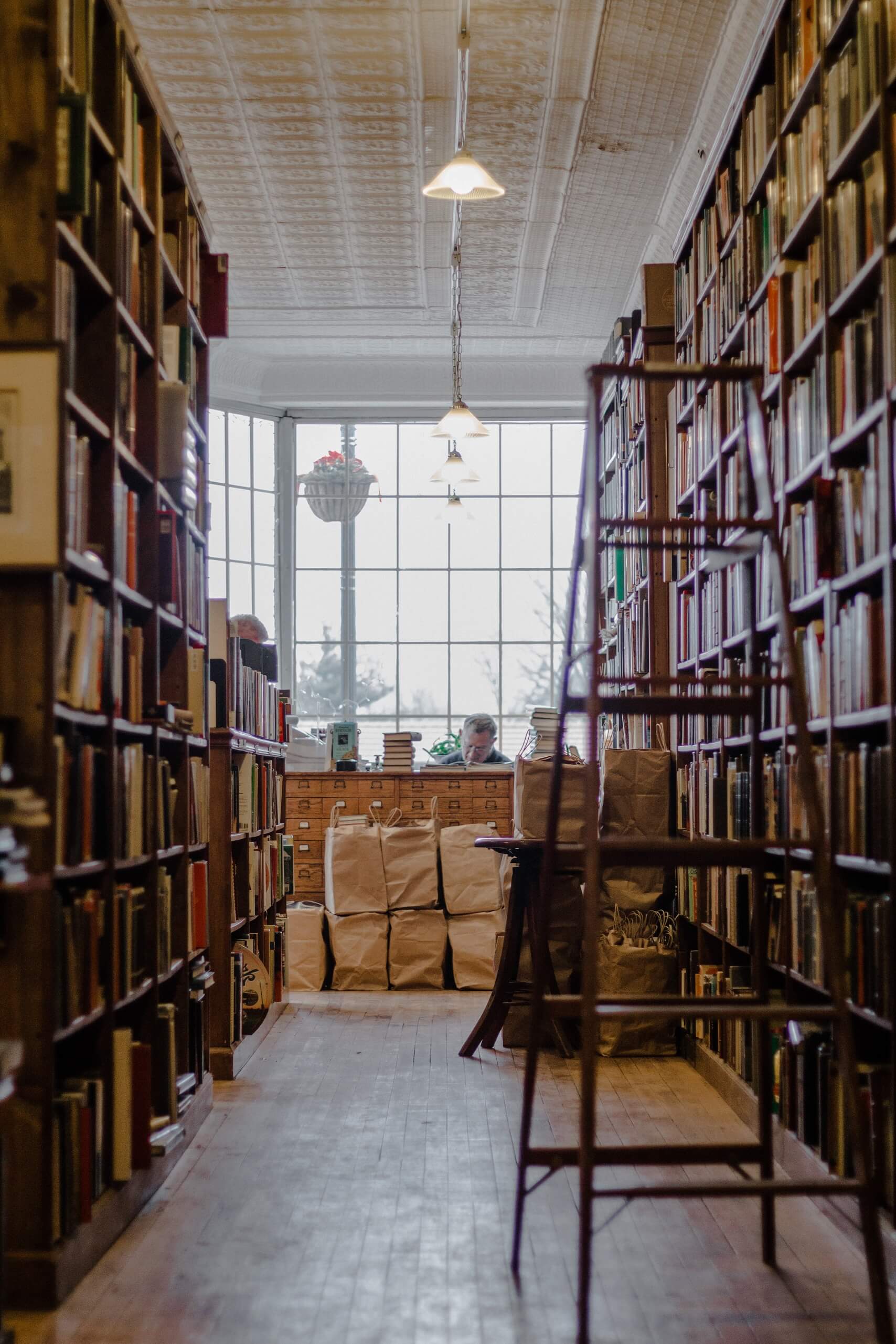 Ladder in an old bookshop with shelves full of books