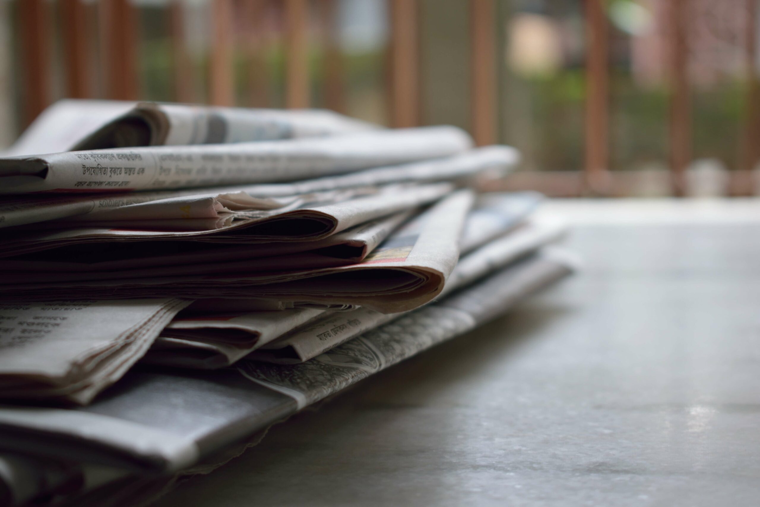 Pile of book and newspaper pages on a table