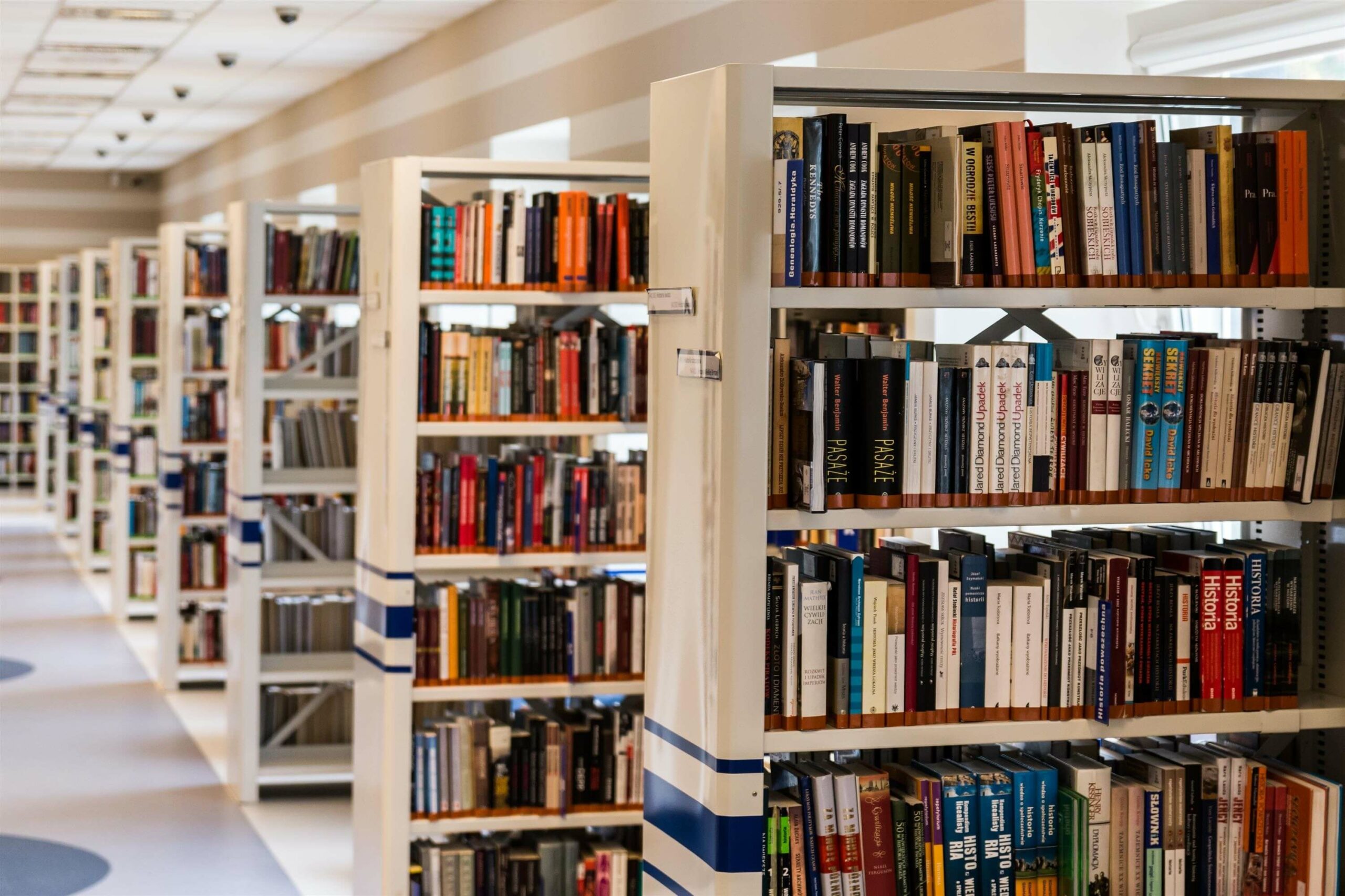 Library with many light-coloured wooden bookshelves