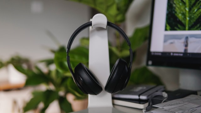 Headphones on a headphone stand on a desk